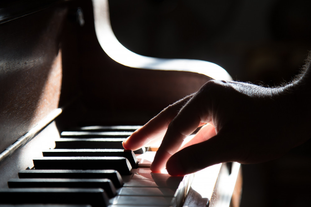 A Man's Hand Playing Piano 