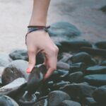 A Woman's Hand Holding A Stone