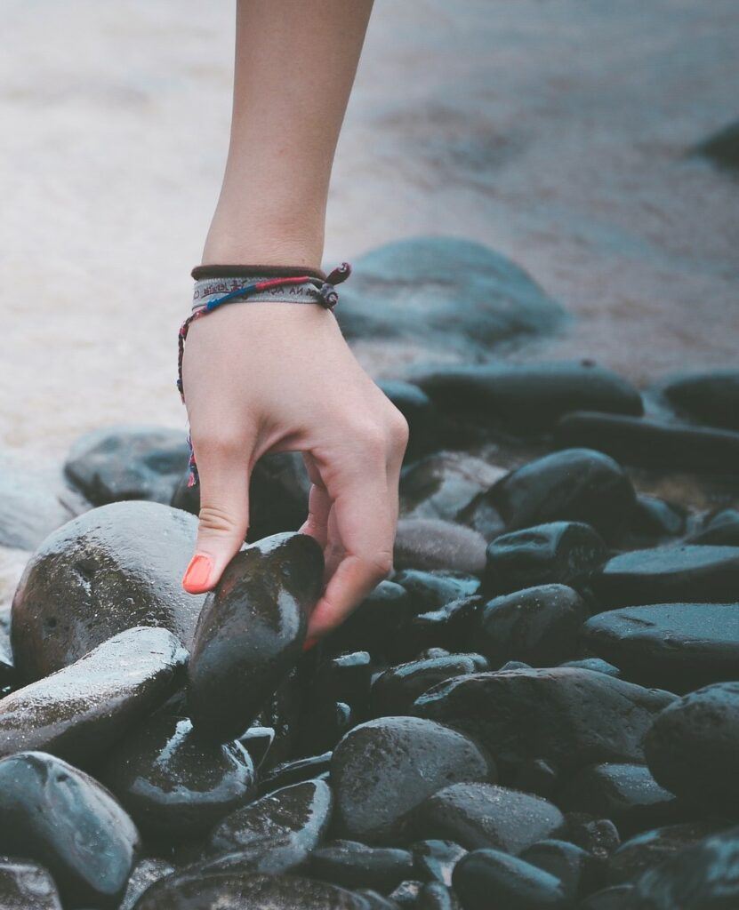 A Woman's Hand Holding A Stone